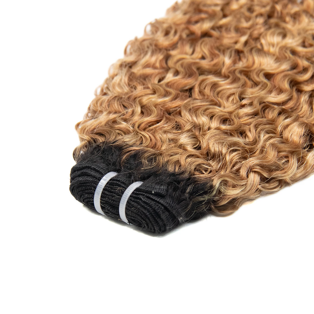 Top view of Ywigs T1B/27/30/613 Water Curl Ultra Thin Genius Weft showing thin flat weft construction and blended color