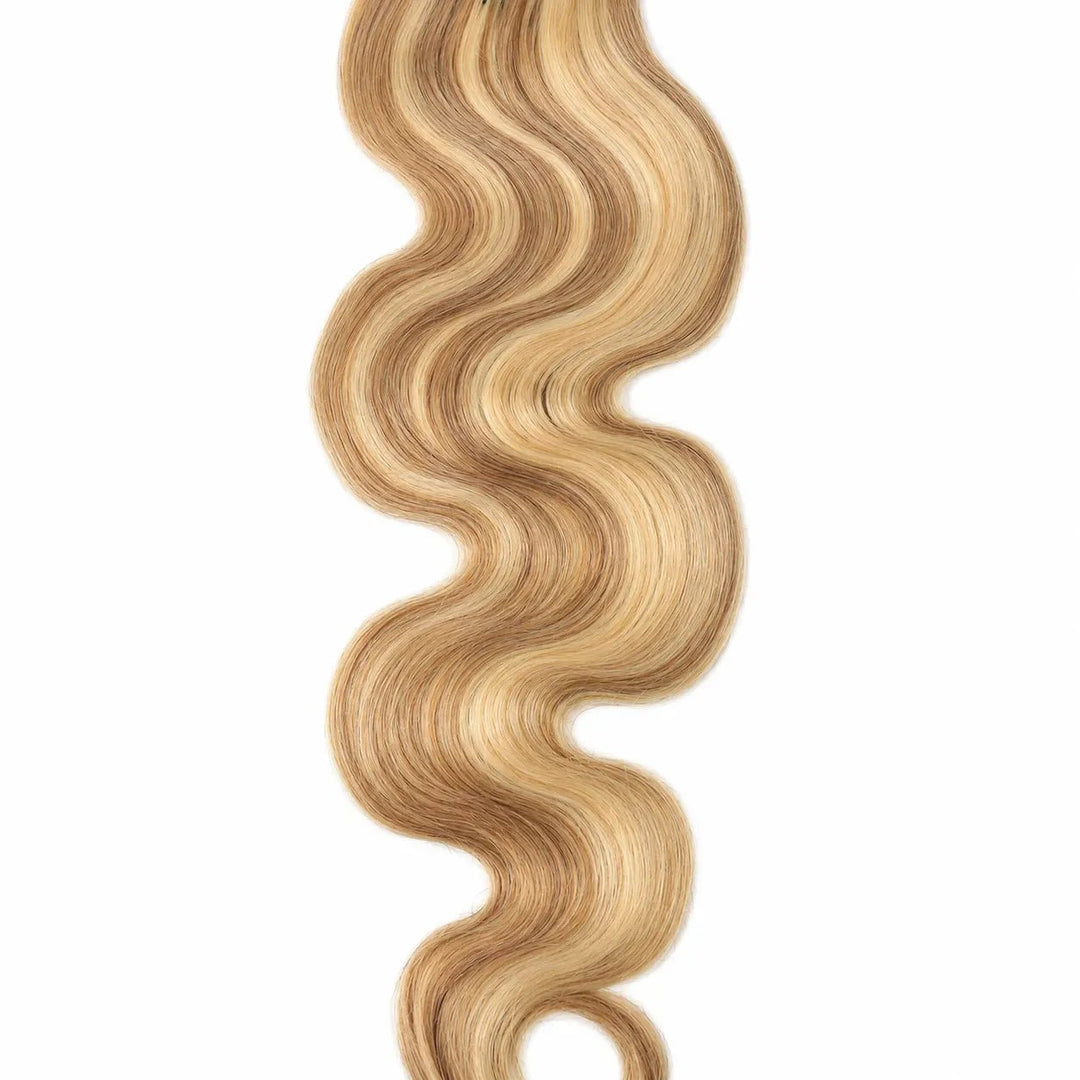 Detailed view of a single Ywigs #27/#613 Body Wave Human Crochet Hair strand, showcasing its defined wave pattern and soft blonde ends.
