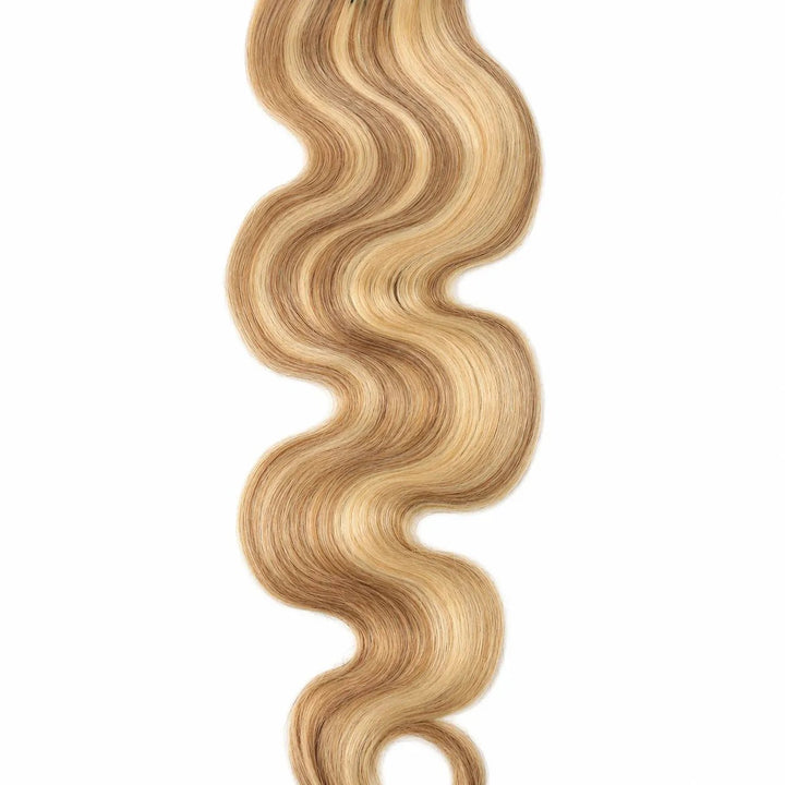 Detailed view of a single Ywigs #27/#613 Body Wave Human Crochet Hair strand, showcasing its defined wave pattern and soft blonde ends.