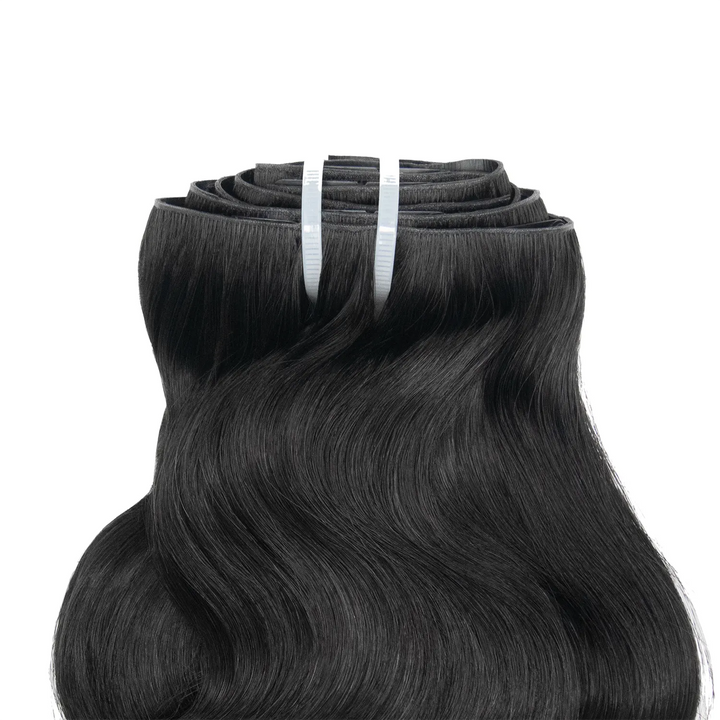 Close-up of Ywigs Invisible Edge Clip In Body Wave Hair Extensions showing defined body wave pattern and natural shine