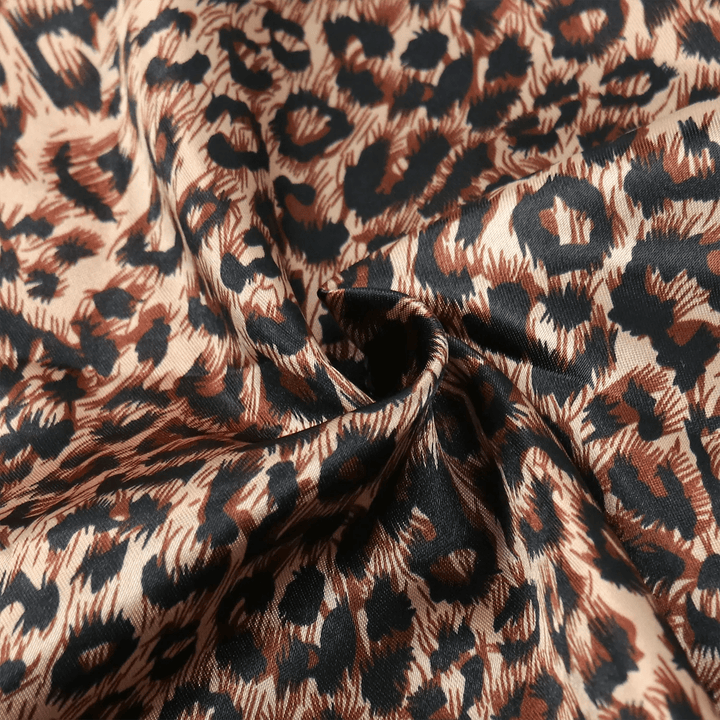 Close-up of Ywigs Leopard Print Satin Hair Scarf showing the smooth satin fabric and leopard print pattern