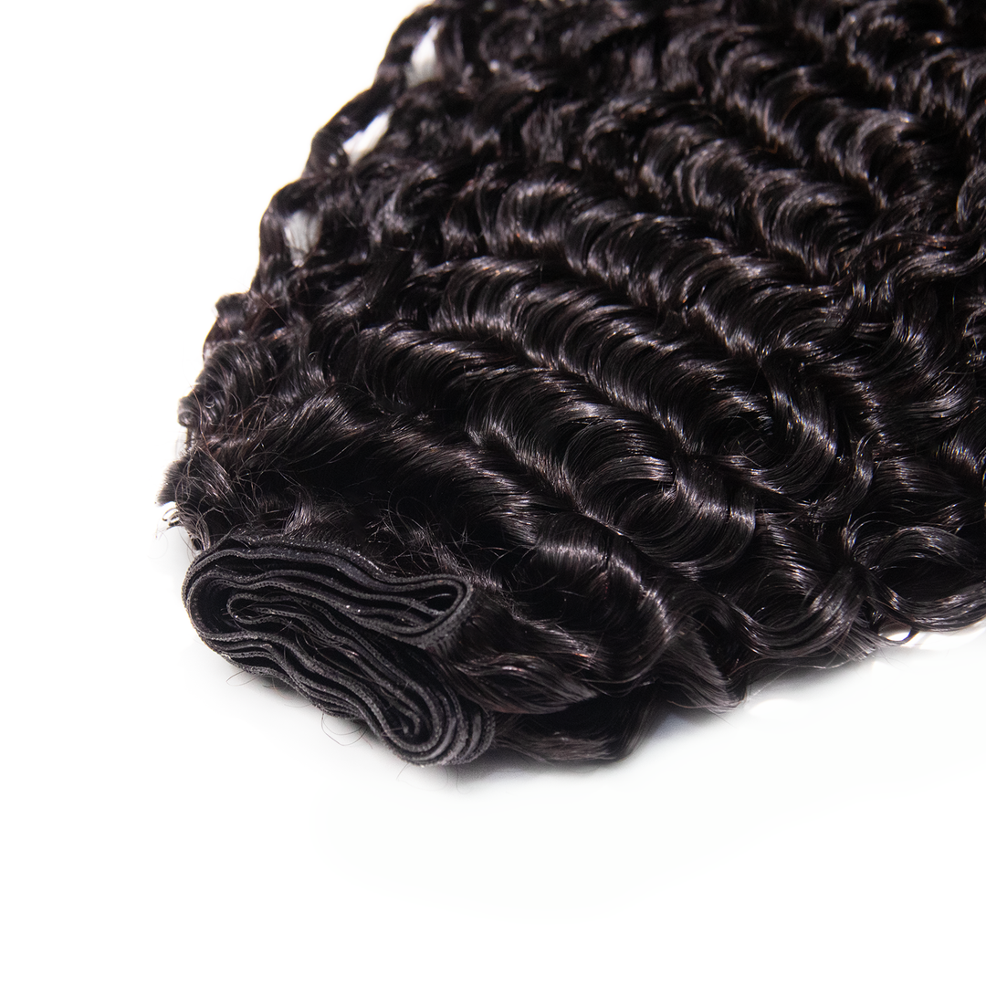 Close-up of Ywigs Water Curly Ultra Thin Genius Weft showing thin and flat weft construction