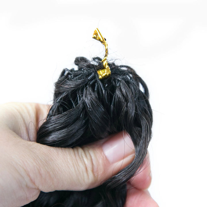Close-up of Ywigs water wave feather crochet hair texture showing defined spiral curl pattern and natural sheen